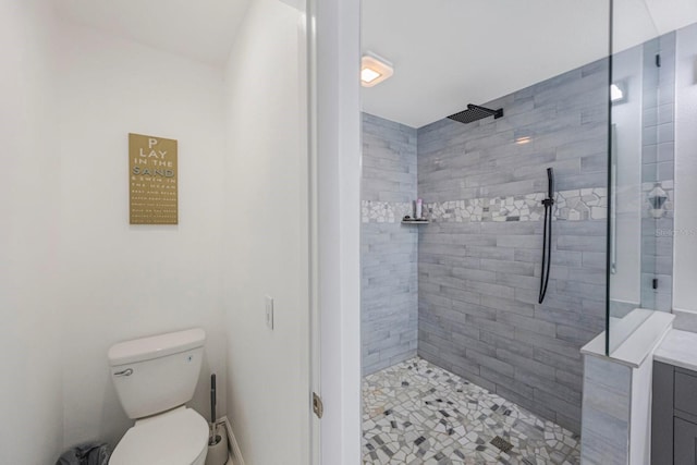 bathroom with tiled shower and toilet