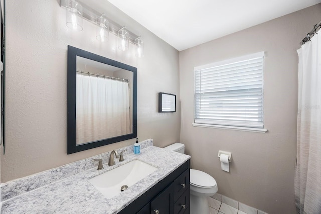 bathroom featuring toilet, baseboards, and vanity