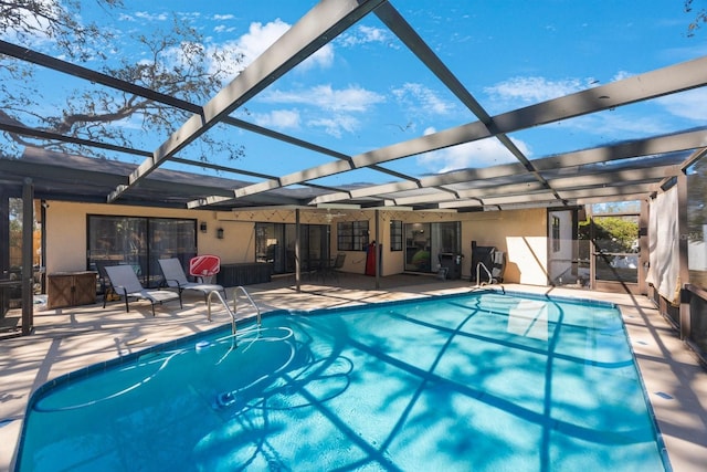 outdoor pool featuring a lanai and a patio area