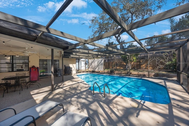 pool with ceiling fan, a patio area, and a lanai