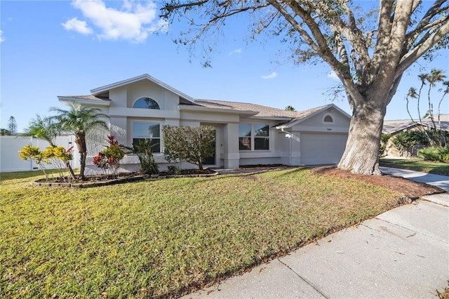 single story home featuring a front yard, fence, an attached garage, and stucco siding