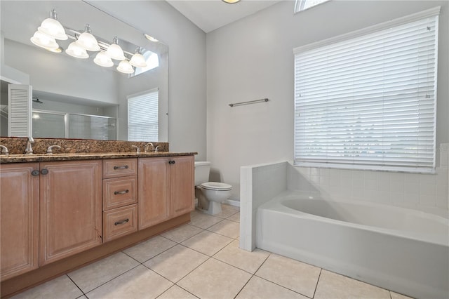 bathroom with tile patterned floors, a stall shower, and a sink