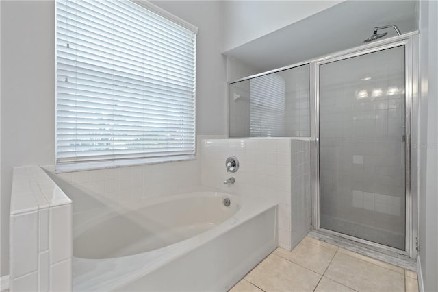 bathroom with tile patterned floors, a garden tub, and a shower stall