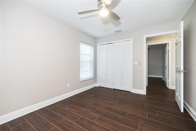 unfurnished bedroom with a closet, baseboards, and wood tiled floor