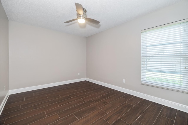 spare room with a textured ceiling, baseboards, wood finish floors, and a ceiling fan