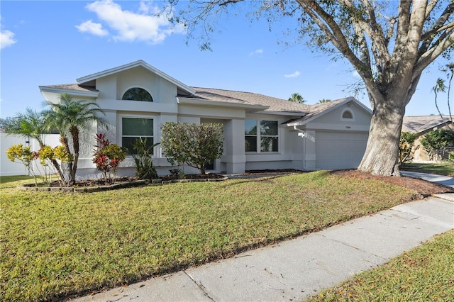 ranch-style house featuring a front yard, a garage, driveway, and stucco siding