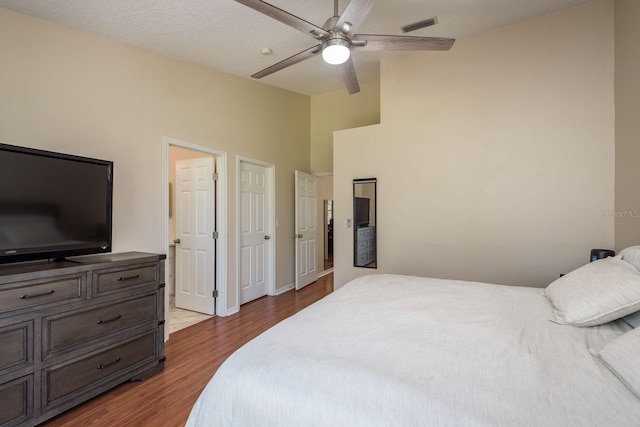 720 Earls Ct, Safety Harbor, FL 34695 - bedroom with ceiling fan, high vaulted ceiling, visible vents, baseboards, and dark wood-style floors