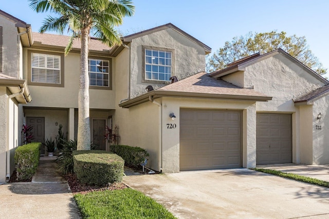 720 Earls Ct, Safety Harbor, FL 34695 - multi unit property with a garage, roof with shingles, concrete driveway, and stucco siding