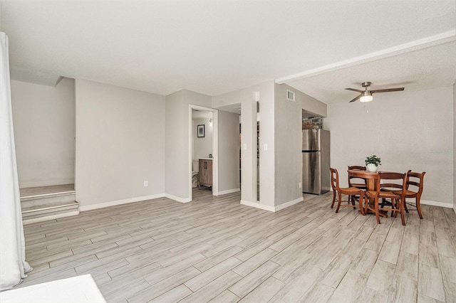 dining area featuring baseboards, visible vents, light wood-type flooring, and ceiling fan