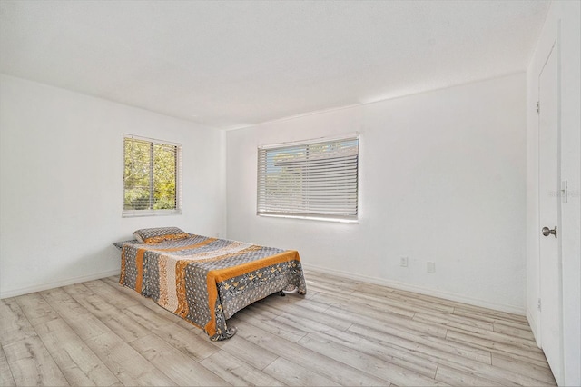 bedroom with baseboards and light wood-style floors