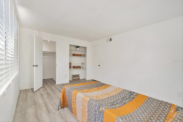 bedroom with visible vents and light wood finished floors