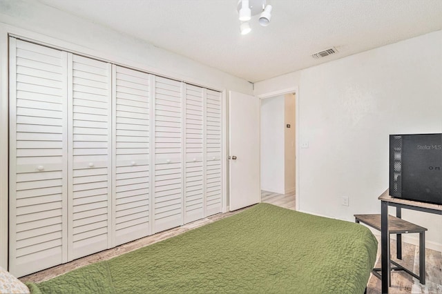 unfurnished bedroom featuring a closet, visible vents, and a textured ceiling