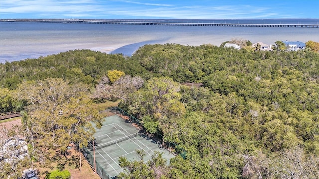 aerial view with a wooded view and a water view