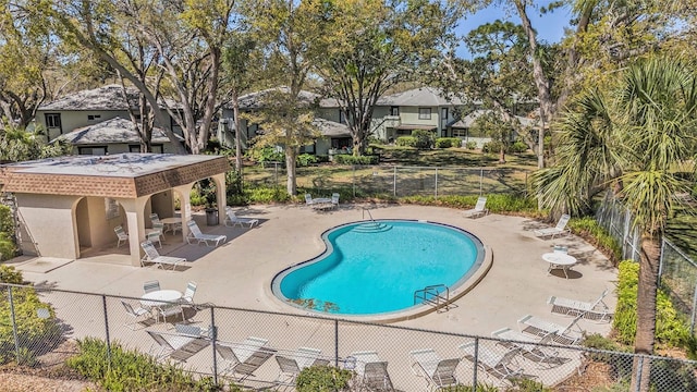 community pool featuring a patio and fence