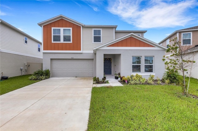 view of front of property with driveway, a front lawn, board and batten siding, and an attached garage