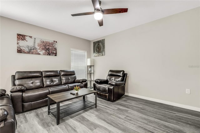 living area featuring ceiling fan, wood finished floors, and baseboards