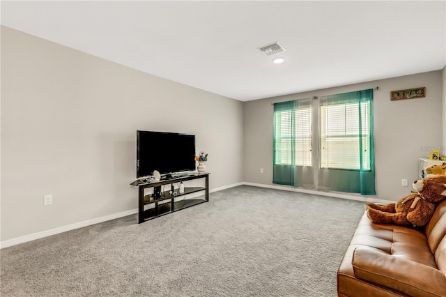 carpeted living area with visible vents and baseboards