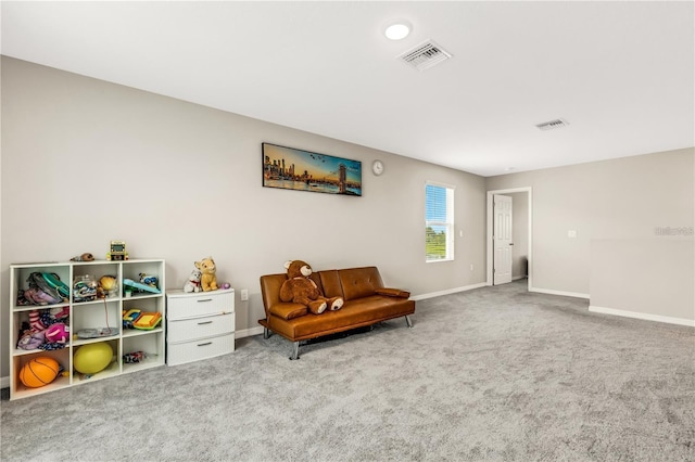 sitting room with carpet, visible vents, and baseboards