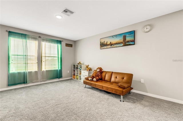 living area featuring carpet floors, visible vents, and baseboards