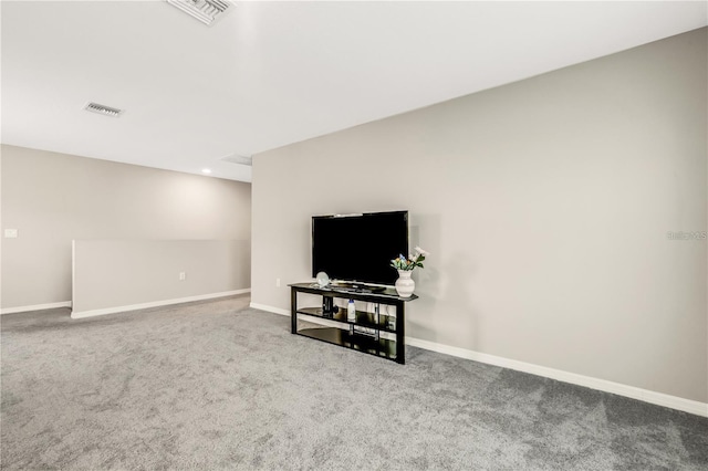 living area with carpet, visible vents, and baseboards