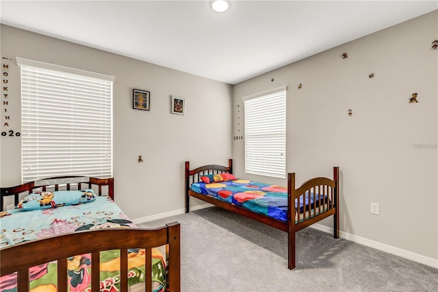 carpeted bedroom with baseboards