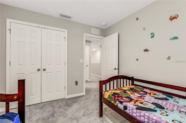 bedroom featuring light carpet, a closet, visible vents, and baseboards