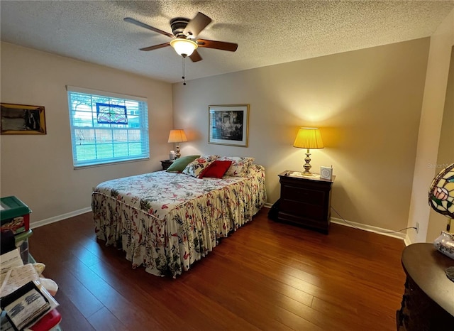 bedroom featuring ceiling fan, a textured ceiling, baseboards, and hardwood / wood-style floors