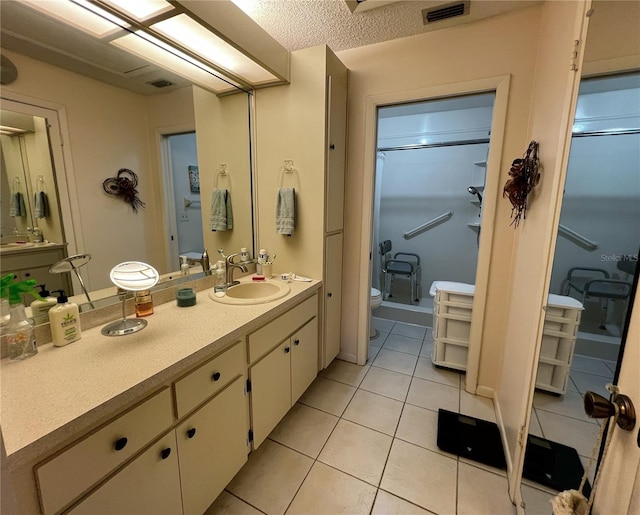 bathroom featuring visible vents, toilet, tile patterned flooring, vanity, and a shower stall