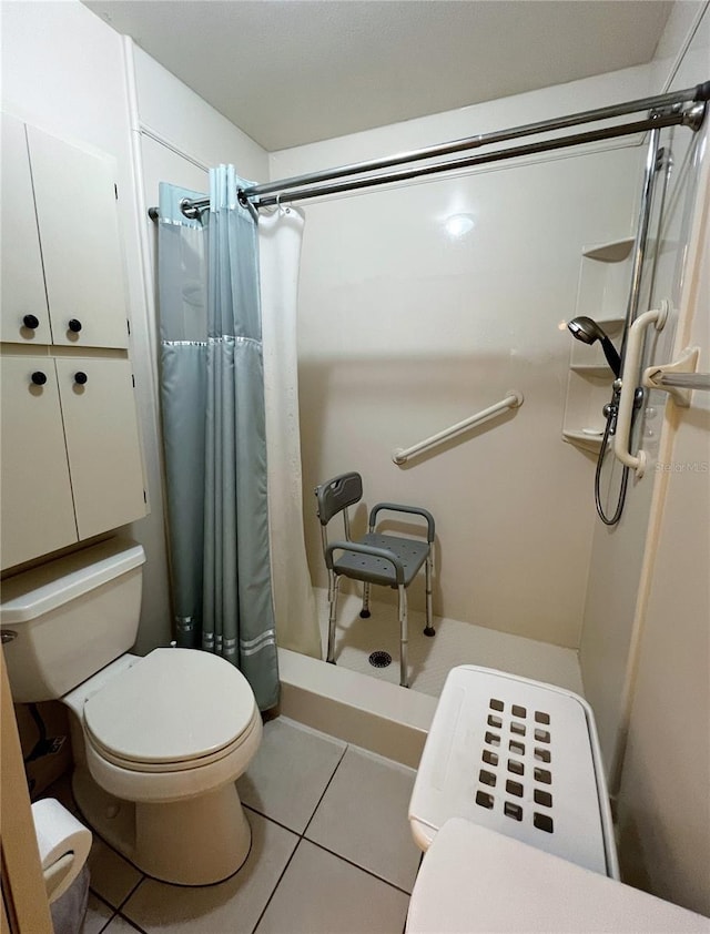 bathroom with toilet, a stall shower, and tile patterned flooring