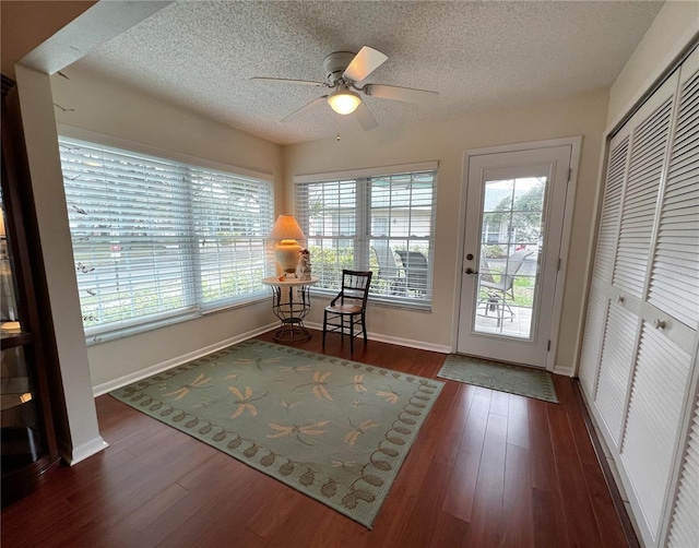 sunroom / solarium featuring ceiling fan