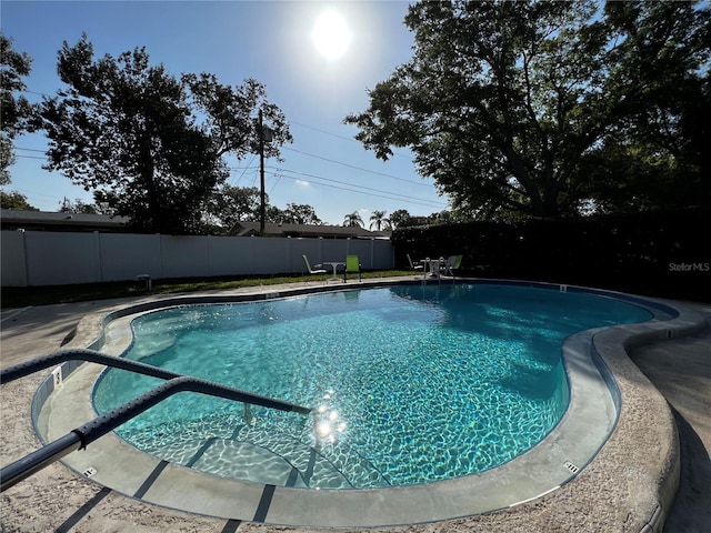 view of swimming pool featuring a fenced backyard and a fenced in pool