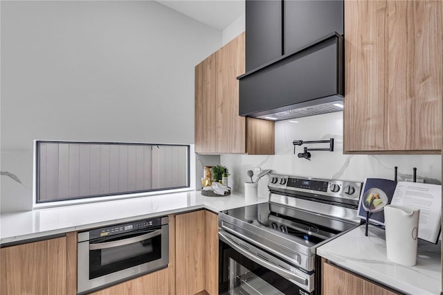 kitchen with appliances with stainless steel finishes, brown cabinets, premium range hood, and modern cabinets