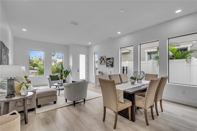 dining space with light wood-type flooring, baseboards, visible vents, and recessed lighting