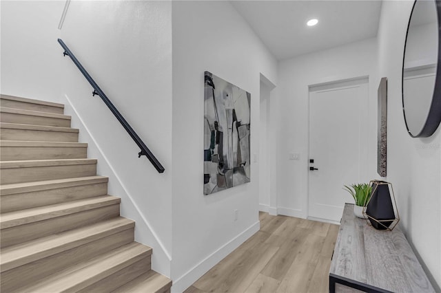 foyer with stairs, recessed lighting, light wood-type flooring, and baseboards