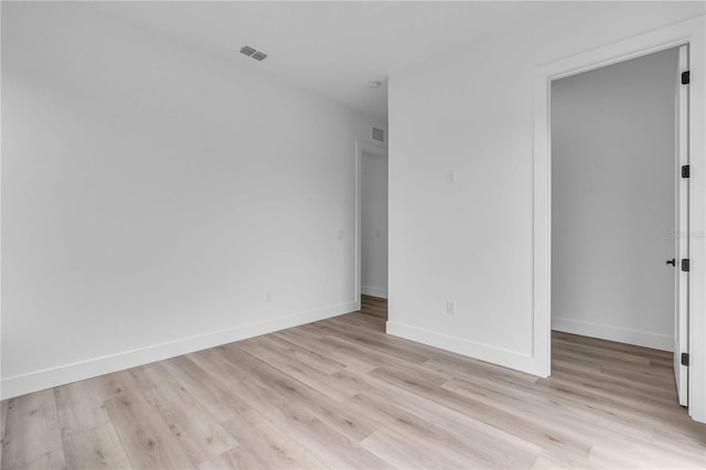 unfurnished bedroom featuring light wood-style floors, visible vents, and baseboards