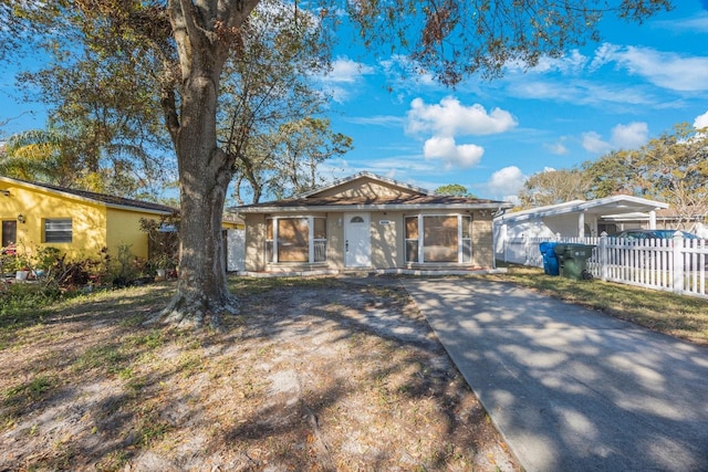 view of front of house with fence and stucco siding