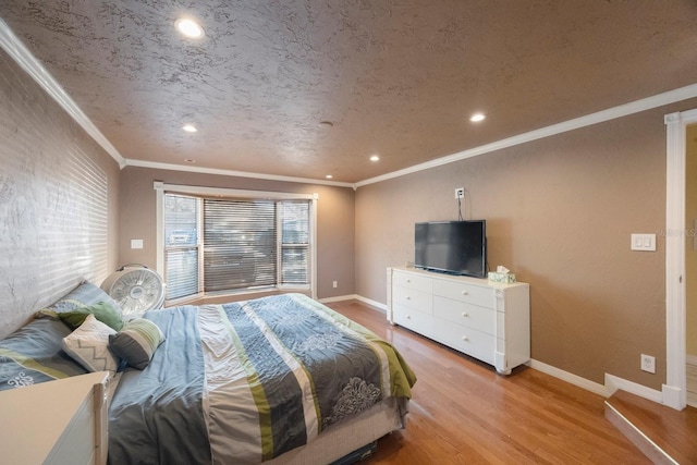 bedroom featuring light wood-style flooring, a textured ceiling, baseboards, and crown molding