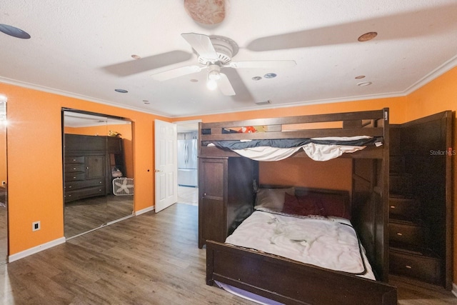 bedroom featuring baseboards, dark wood-style floors, ceiling fan, freestanding refrigerator, and crown molding