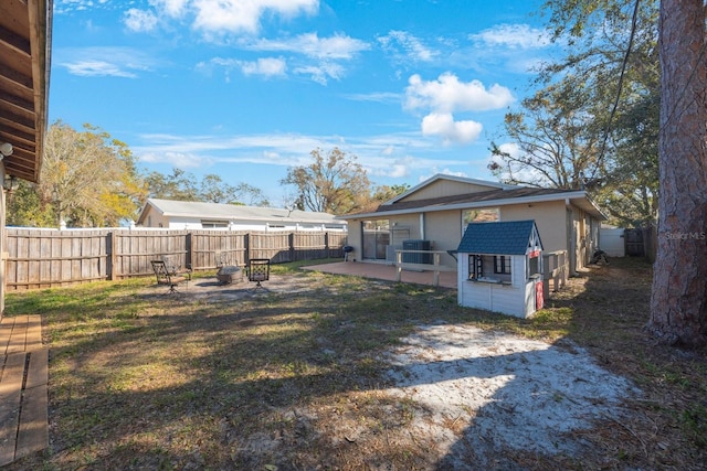 back of house featuring central AC and a fenced backyard