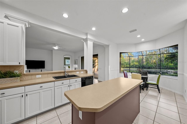 kitchen with a sink, black dishwasher, recessed lighting, light countertops, and light tile patterned floors