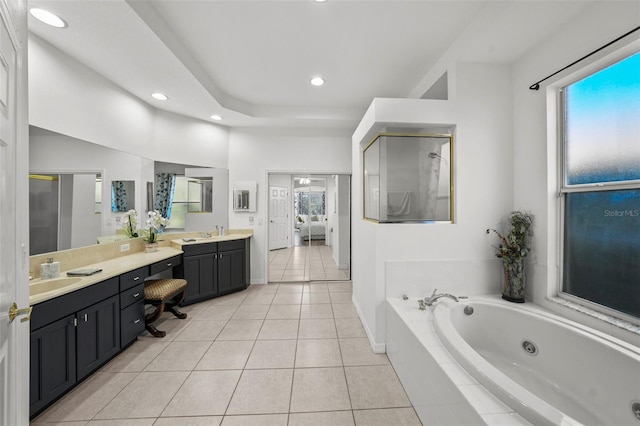 ensuite bathroom featuring a whirlpool tub, recessed lighting, connected bathroom, tile patterned flooring, and vanity