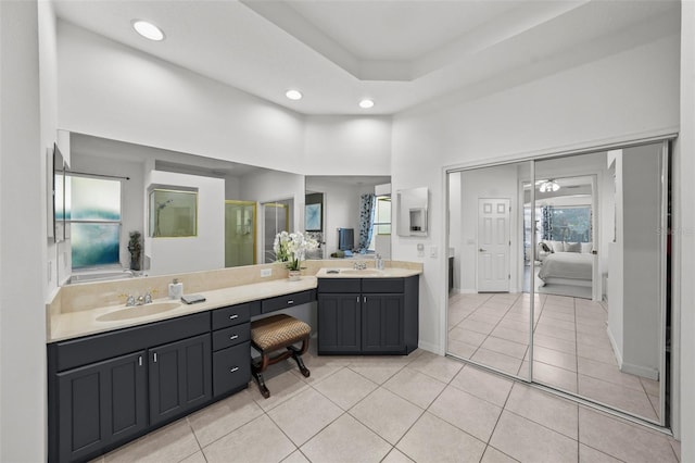 full bathroom with a sink, recessed lighting, double vanity, and tile patterned flooring