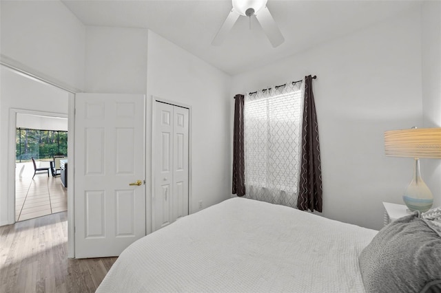 bedroom featuring ceiling fan, a closet, and wood finished floors