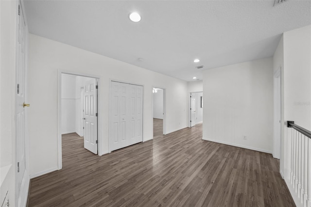 unfurnished room featuring recessed lighting, dark wood-style floors, and baseboards