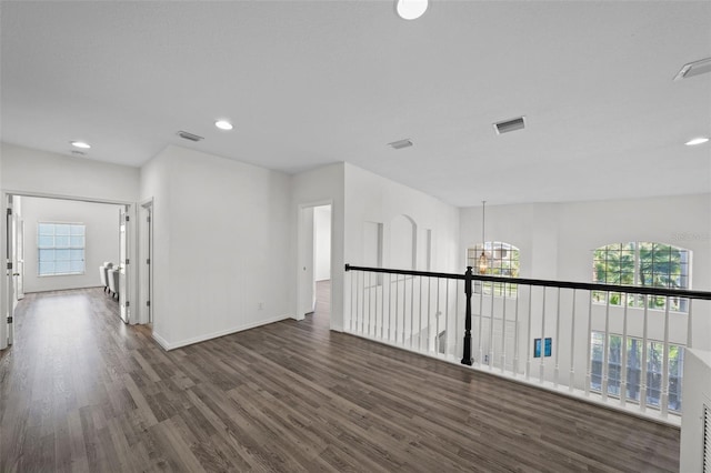 unfurnished room featuring recessed lighting, wood finished floors, and visible vents