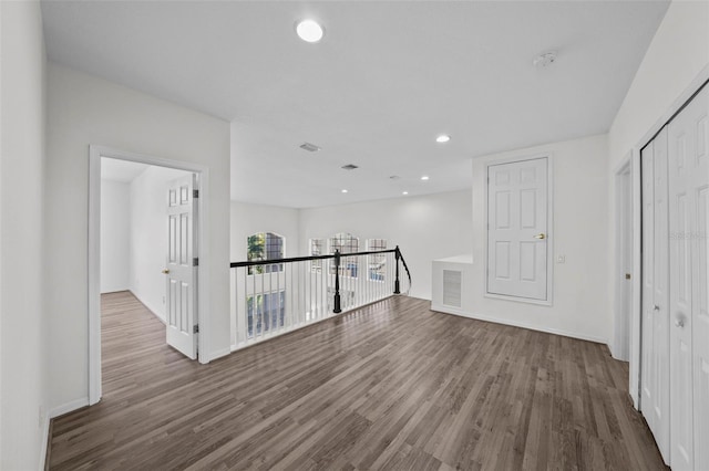 unfurnished room featuring visible vents, recessed lighting, wood finished floors, and baseboards