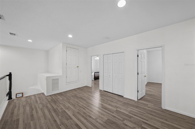 interior space featuring recessed lighting, wood finished floors, and visible vents