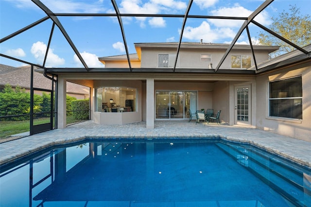 outdoor pool with a lanai and a patio