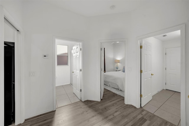 unfurnished bedroom with baseboards and light wood-type flooring