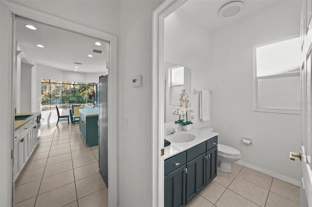 bathroom with tile patterned flooring, baseboards, toilet, recessed lighting, and vanity